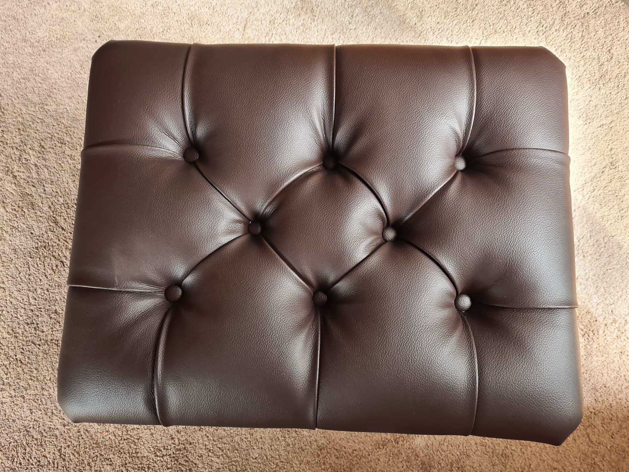 Striped dining chair seat being reupholstered in the workshop
